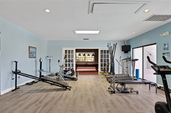 a room with pool table and windows