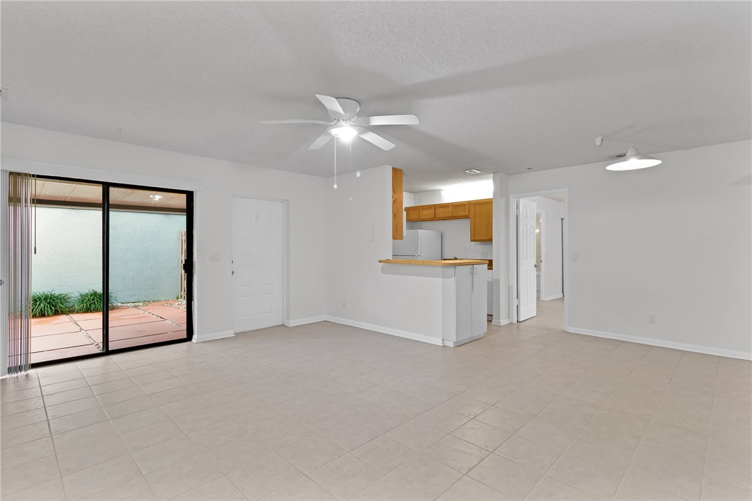 1136 Breezy Way, Unit 3B Sebastian, FL 32958 - Photo 6 of 34 an empty room with fan and windows