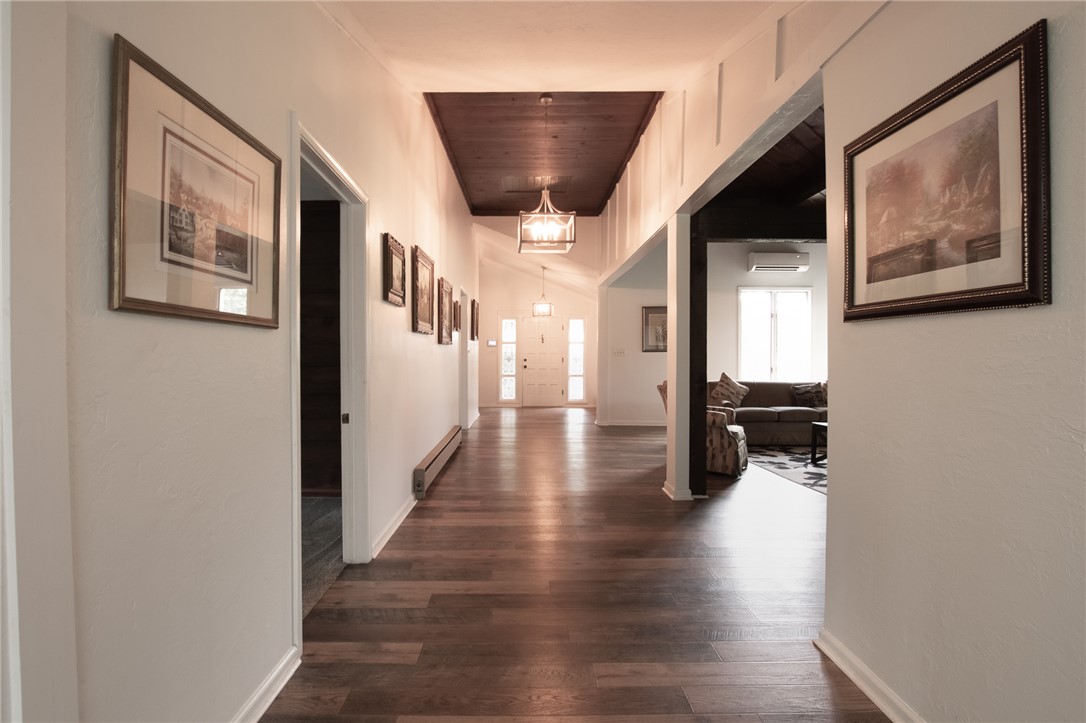 200 Chenault Road Townville, SC 29689 - Photo 16 of 47 Enter into a lengthy, well-lit hallway featuring rich wood flooring and a classic coffered ceiling.