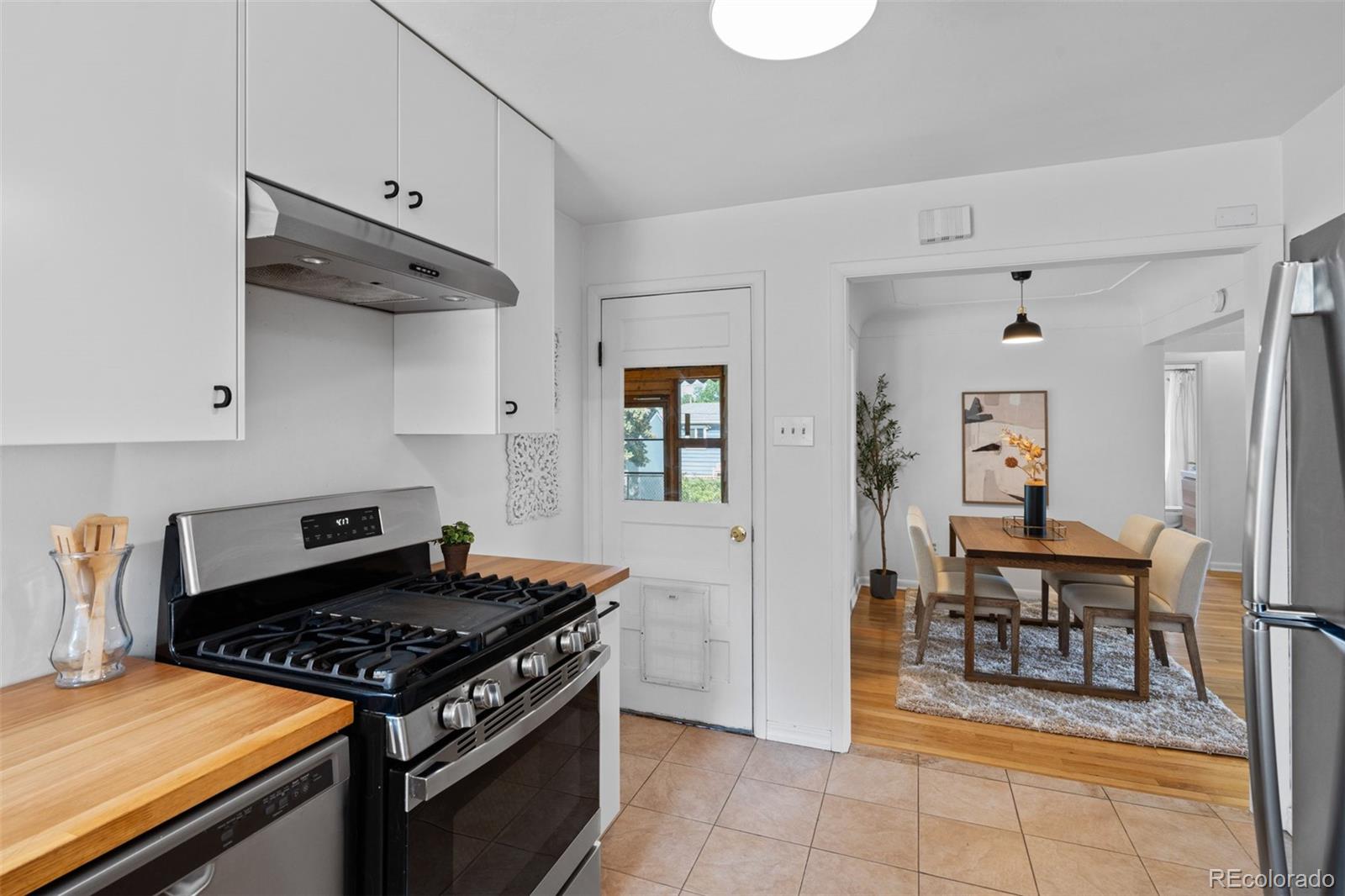 6755 West 45th Avenue Wheat Ridge, CO 80033 - Photo 16 of 27 a kitchen with a stove and a table