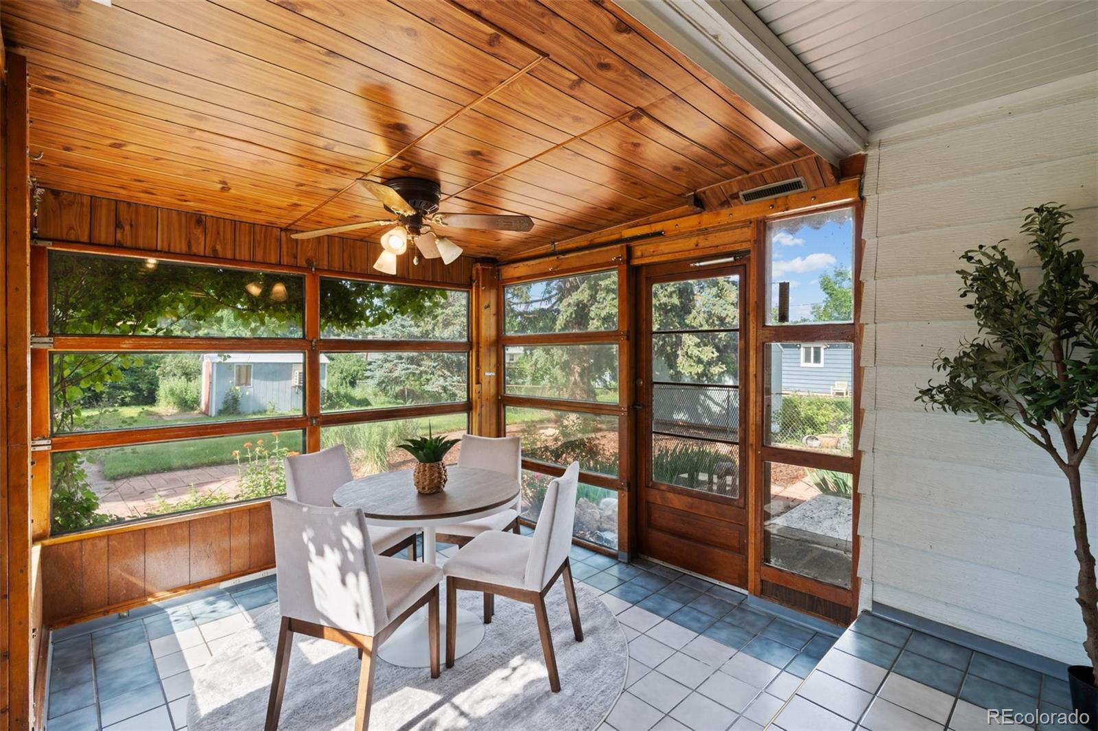 6755 West 45th Avenue Wheat Ridge, CO 80033 - Photo 18 of 27 a view of a patio with table and chairs and potted plants