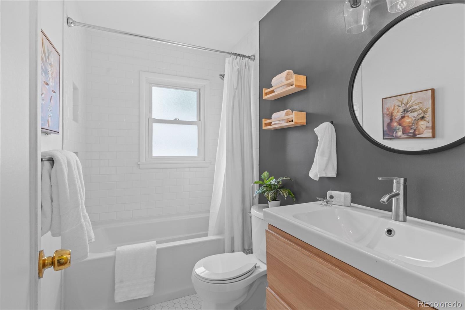 6755 West 45th Avenue Wheat Ridge, CO 80033 - Photo 20 of 27 a bathroom with a sink toilet and shower