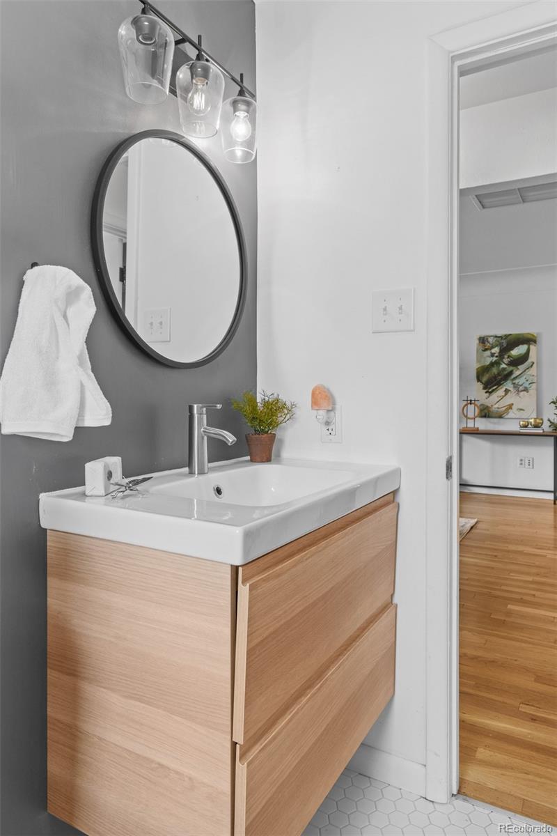 6755 West 45th Avenue Wheat Ridge, CO 80033 - Photo 21 of 27 a bathroom with a sink and a mirror