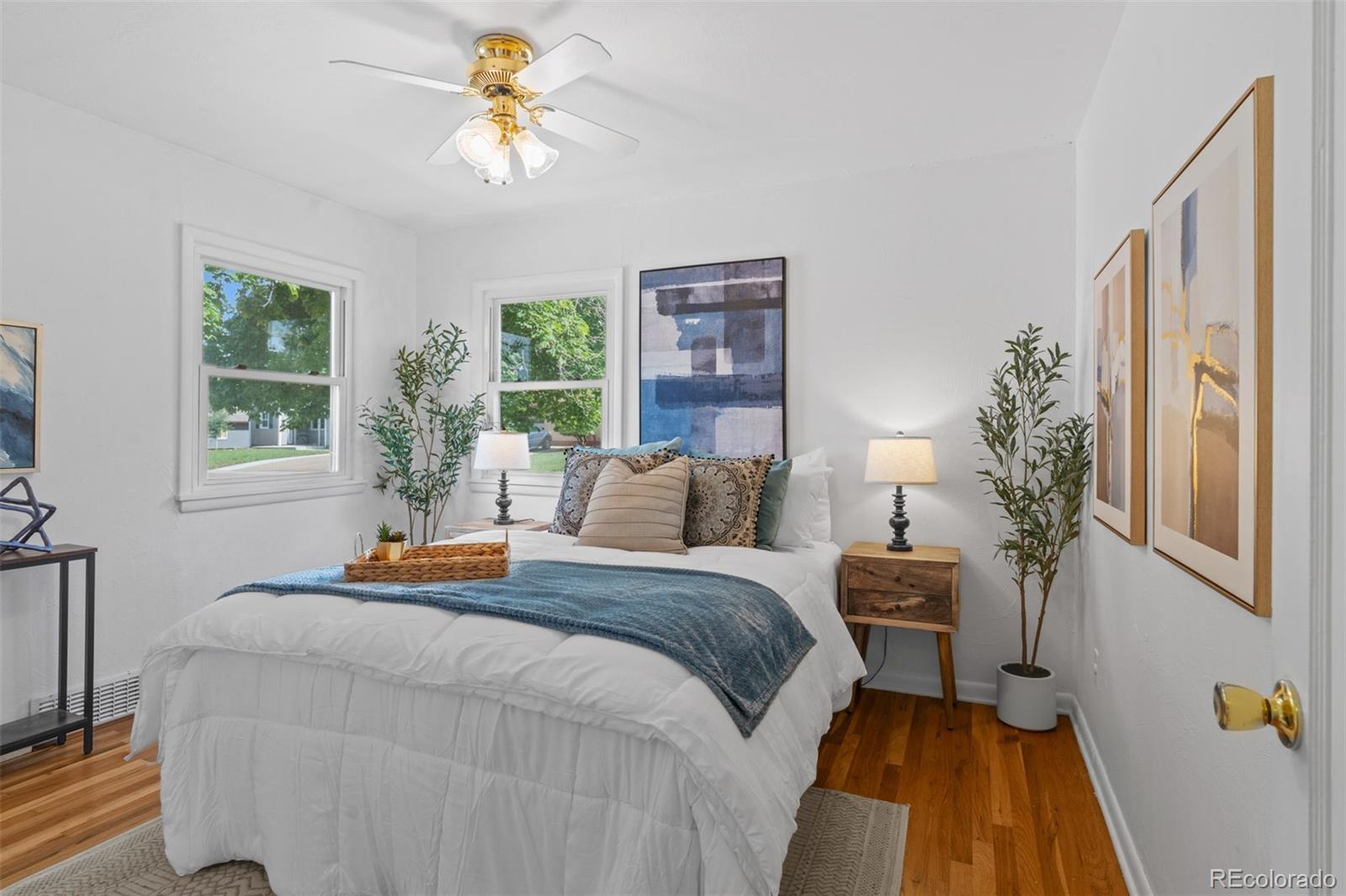 6755 West 45th Avenue Wheat Ridge, CO 80033 - Photo 22 of 27 a bed room with a bed and a chandelier