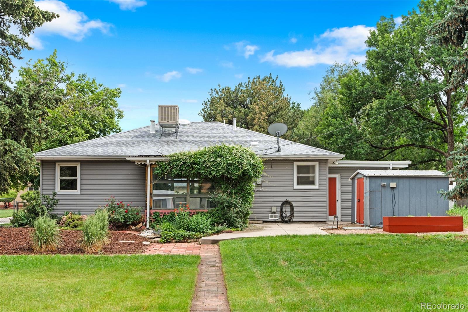 6755 West 45th Avenue Wheat Ridge, CO 80033 - Photo 23 of 27 a view of a house with a yard