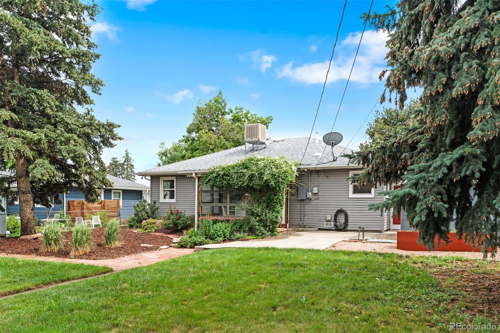 6755 West 45th Avenue Wheat Ridge, CO 80033 - Photo 24 of 27 a view of a house with backyard and a tree