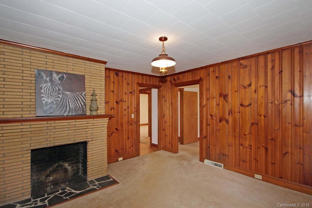 150 Rockwell Road Rockwell, NC 28138 - Photo 11 of 34 a living room with furniture a fireplace and a flat screen tv