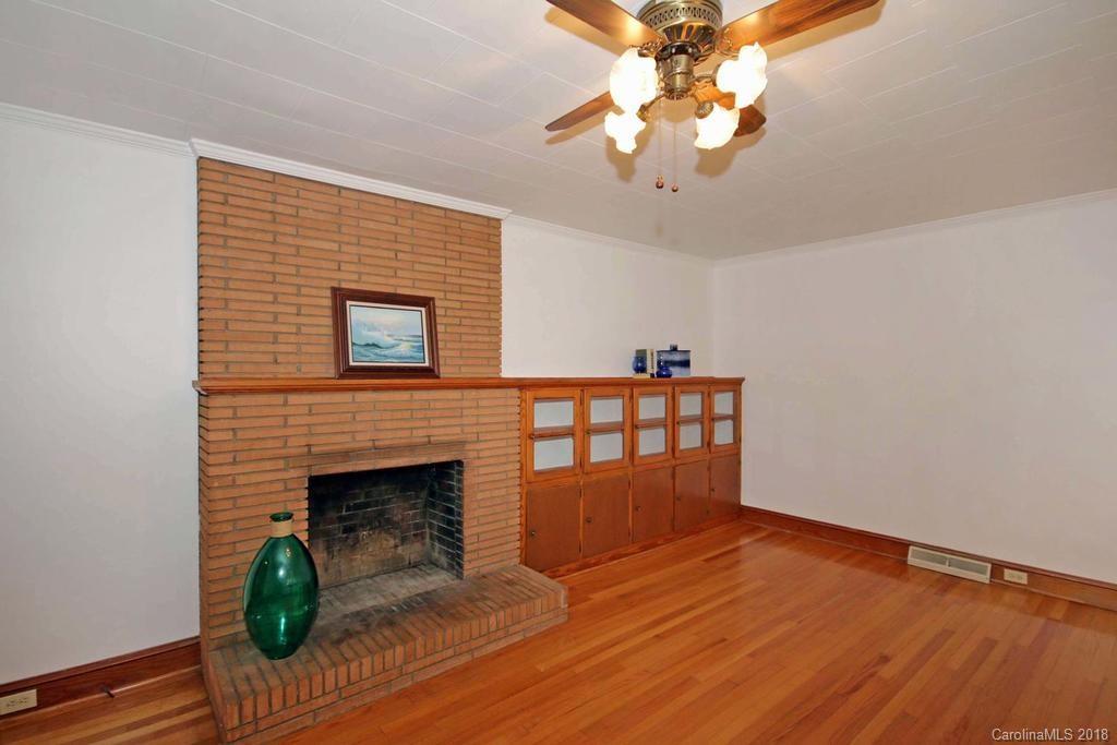 150 Rockwell Road Rockwell, NC 28138 - Photo 7 of 34 a view of an empty room with wooden floor and a fireplace