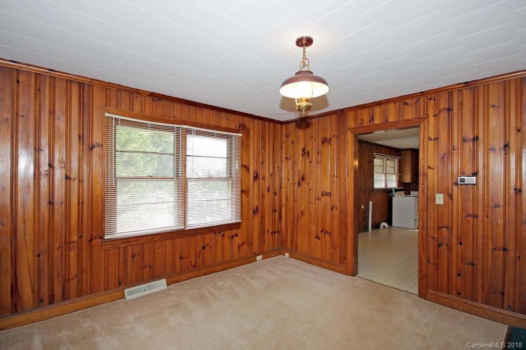 150 Rockwell Road Rockwell, NC 28138 - Photo 10 of 34 an empty room with windows and chandelier fan
