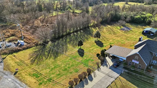 an aerial view of residential building and lake
