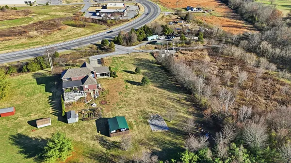 an aerial view of residential houses with outdoor space