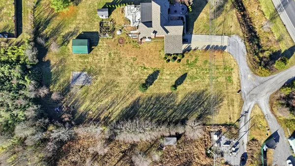 an aerial view of a house with a lake view