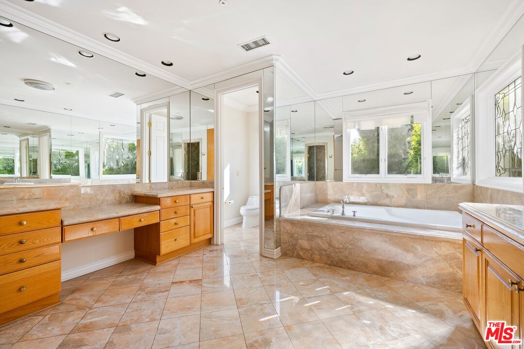 625 Foothill Road Beverly Hills, CA 90210 - Photo 15 of 22 a large bathroom with a large tub shower and sink