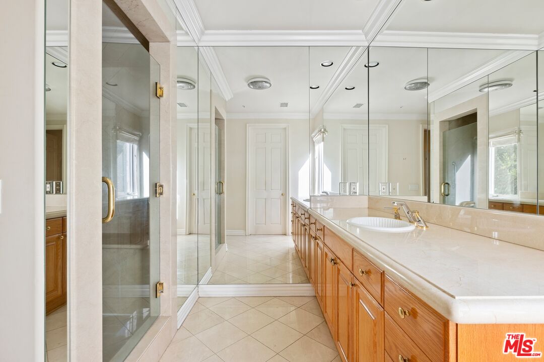 625 Foothill Road Beverly Hills, CA 90210 - Photo 17 of 22 a spacious bathroom with a double vanity sink mirror and shower
