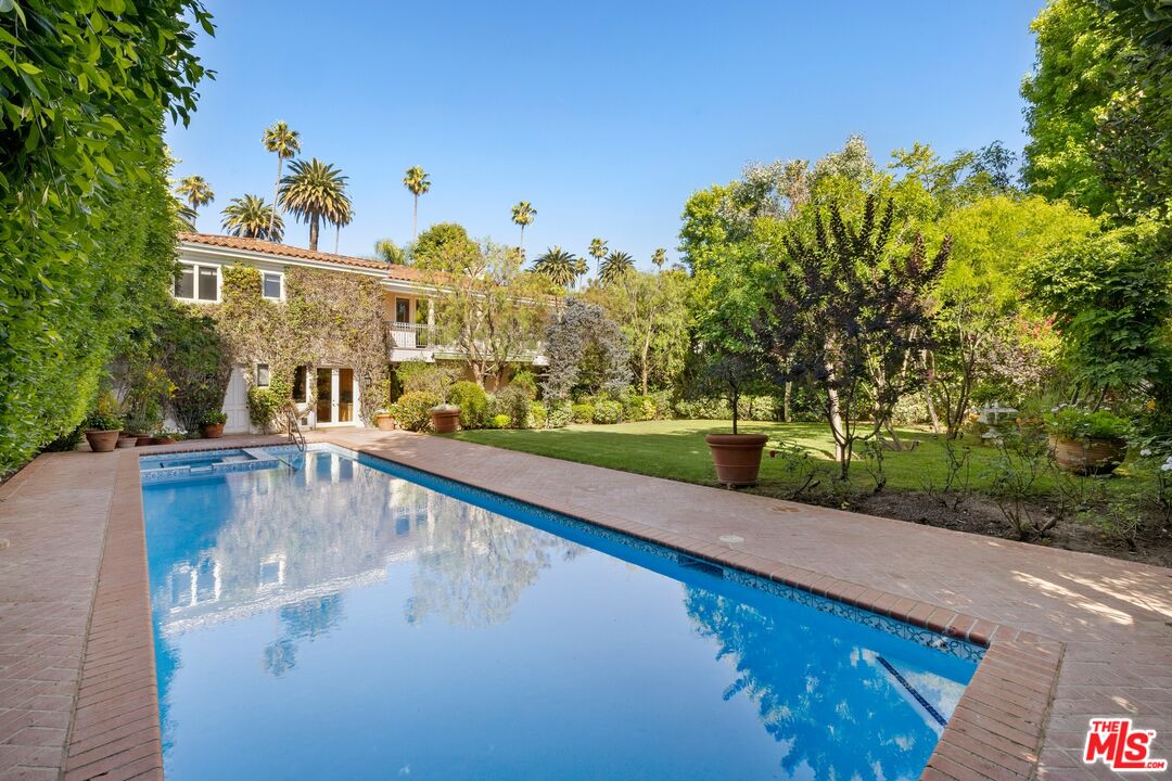 625 Foothill Road Beverly Hills, CA 90210 - Photo 2 of 22 a view of a swimming pool with a yard