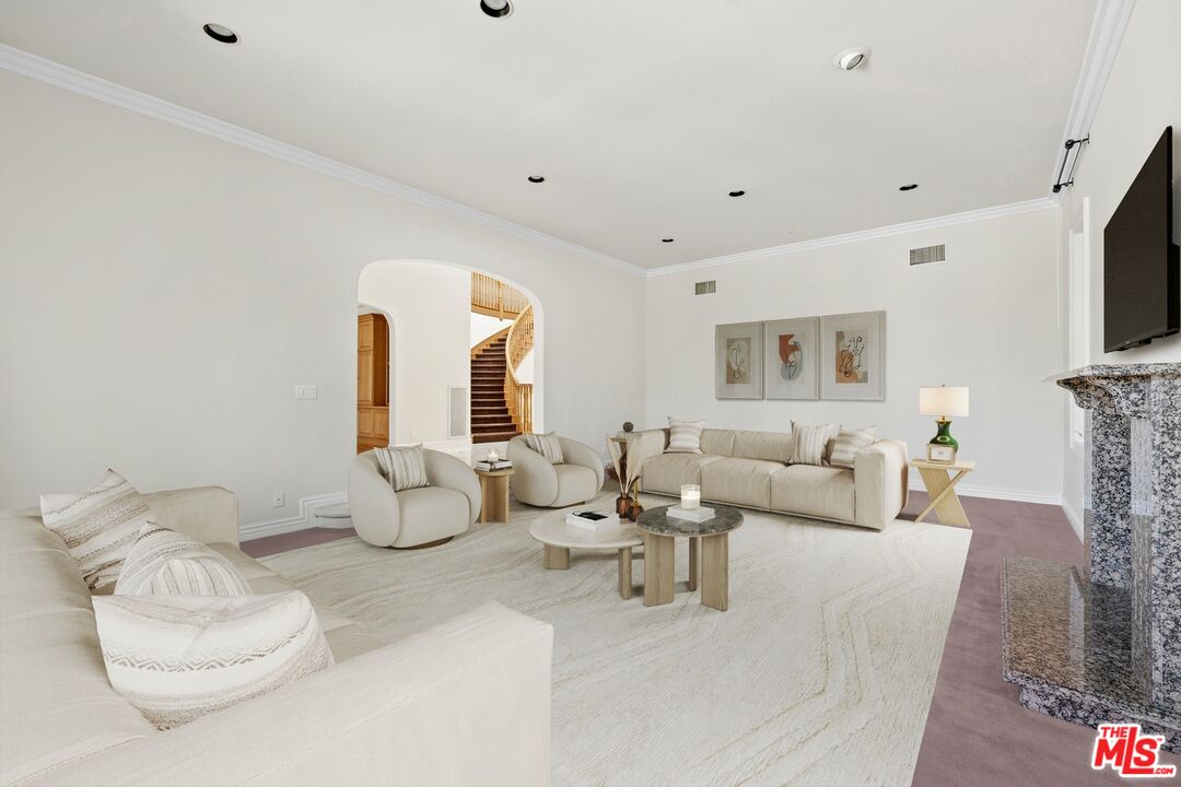 625 Foothill Road Beverly Hills, CA 90210 - Photo 4 of 22 a living room with furniture and a flat screen tv