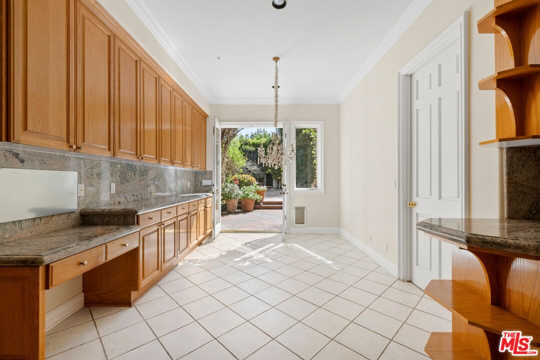 625 Foothill Road Beverly Hills, CA 90210 - Photo 8 of 22 a kitchen with sink cabinets and window