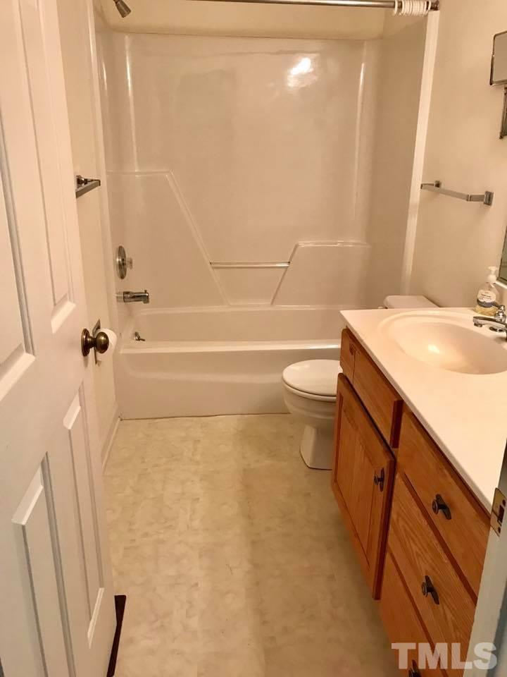 144 Ruff Davis Road Roxboro, NC 27574 - Photo 11 of 16 a bathroom with a sink a toilet and shower