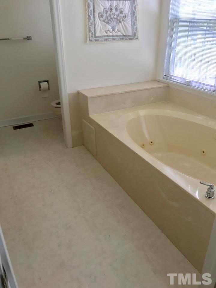 144 Ruff Davis Road Roxboro, NC 27574 - Photo 12 of 16 a bathroom with a bathtub and window