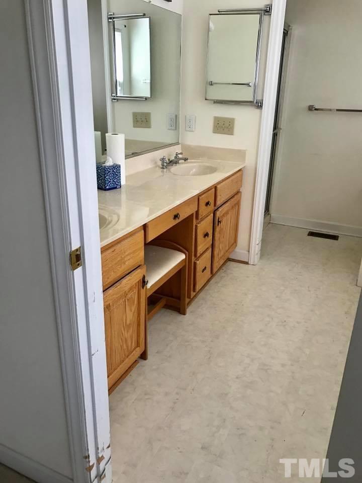 144 Ruff Davis Road Roxboro, NC 27574 - Photo 13 of 16 a bathroom with a sink and a mirror
