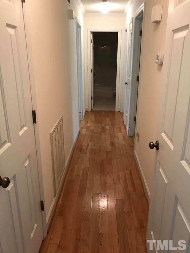 144 Ruff Davis Road Roxboro, NC 27574 - Photo 14 of 16 a view of a hallway with wooden floor