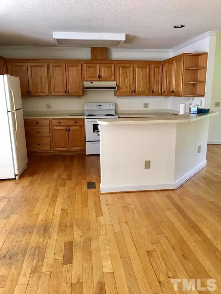 144 Ruff Davis Road Roxboro, NC 27574 - Photo 5 of 16 a kitchen with a sink a stove and a refrigerator