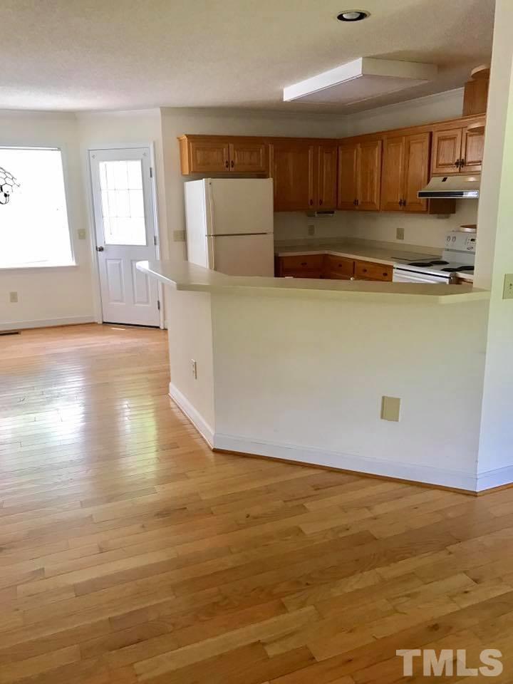 144 Ruff Davis Road Roxboro, NC 27574 - Photo 7 of 16 a kitchen with granite countertop a stove and a refrigerator