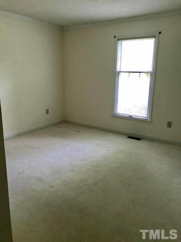 144 Ruff Davis Road Roxboro, NC 27574 - Photo 10 of 16 an empty room with a window