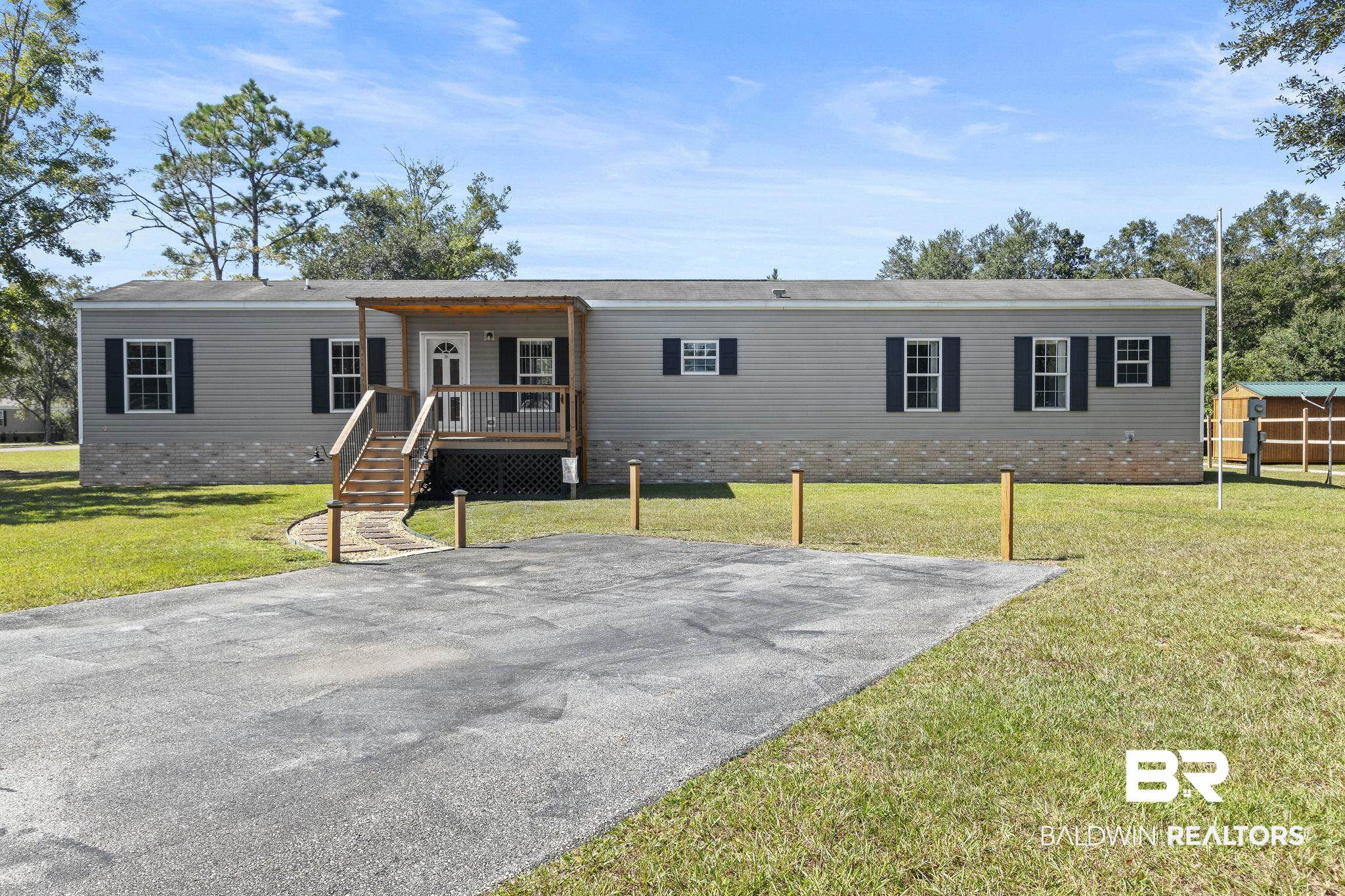 6870 Cecilia Court Theodore, AL 36582 - Photo 2 of 83 Manufactured / mobile home with a front lawn and covered porch