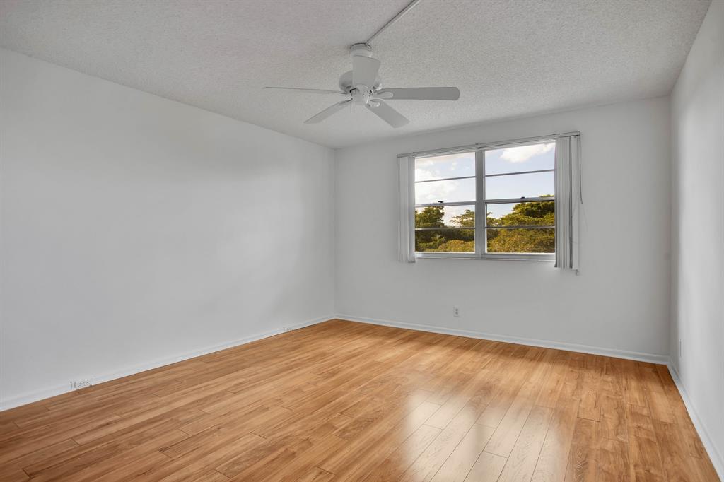 1601 Abaco Drive, Unit D4 Coconut Creek, FL 33066 - Photo 20 of 30 wooden floor in an empty room with a window