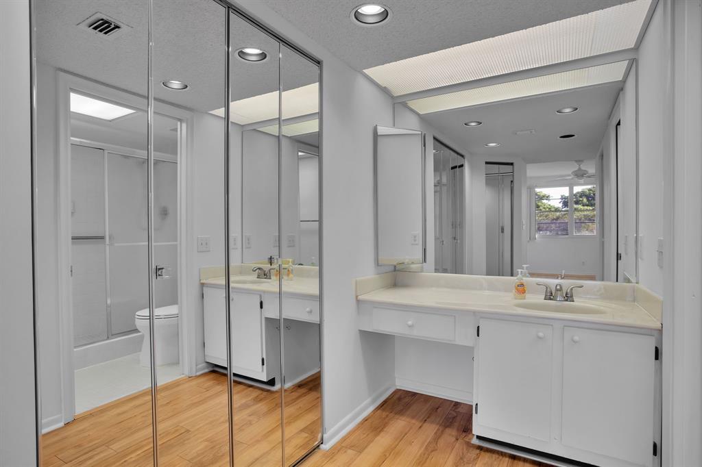 1601 Abaco Drive, Unit D4 Coconut Creek, FL 33066 - Photo 23 of 30 a bathroom with a double vanity sink a mirror and a shower