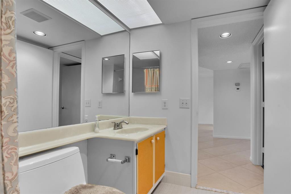 1601 Abaco Drive, Unit D4 Coconut Creek, FL 33066 - Photo 26 of 30 a bathroom with a sink a toilet and shower