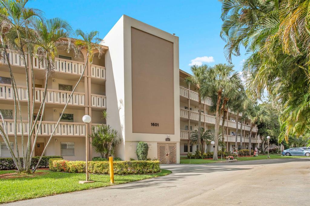 1601 Abaco Drive, Unit D4 Coconut Creek, FL 33066 - Photo 28 of 30 front view of a building with a street