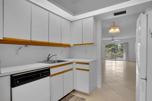 a kitchen with a sink cabinets and a window