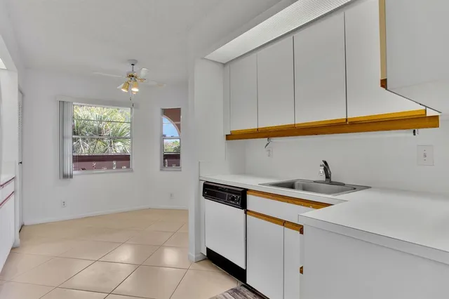 a kitchen with granite countertop a sink and cabinets