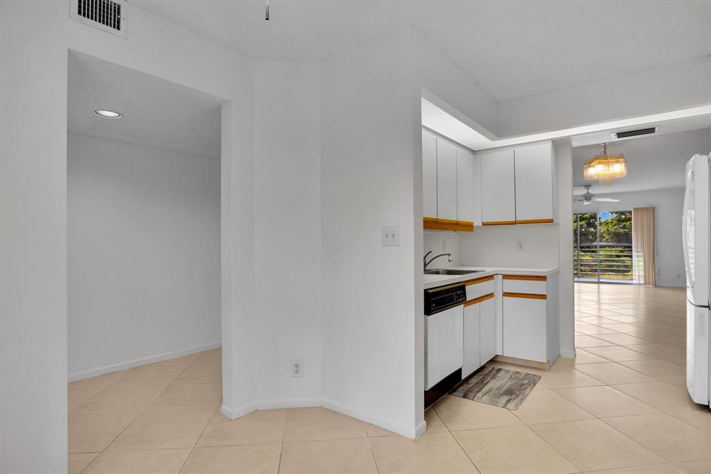 1601 Abaco Drive, Unit D4 Coconut Creek, FL 33066 - Photo 8 of 30 a kitchen with granite countertop a sink and cabinets