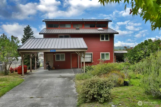 a front view of a house with a garden