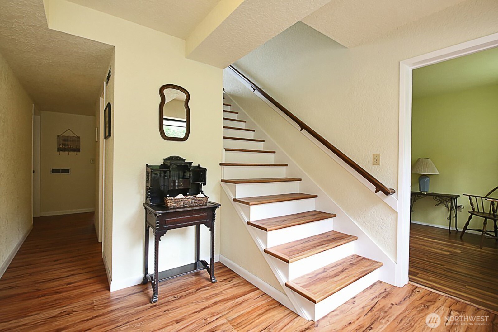 8122 Autumn Lane Clinton, WA 98236 - Photo 7 of 35 a view of a hallway with wooden floor and staircase