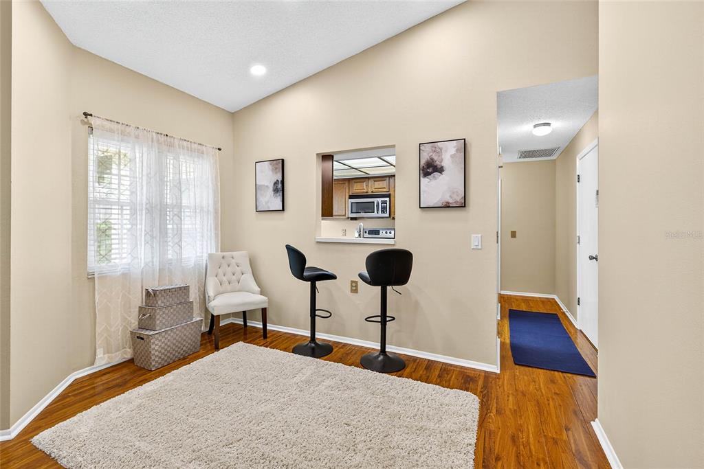 4658 Wallingford Court New Port Richey, FL 34655 - Photo 4 of 48 a bedroom with a bed and a bookshelf with wooden floor