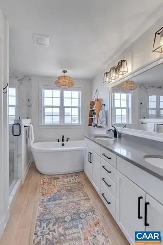 a white bath tub sitting next to a white sink