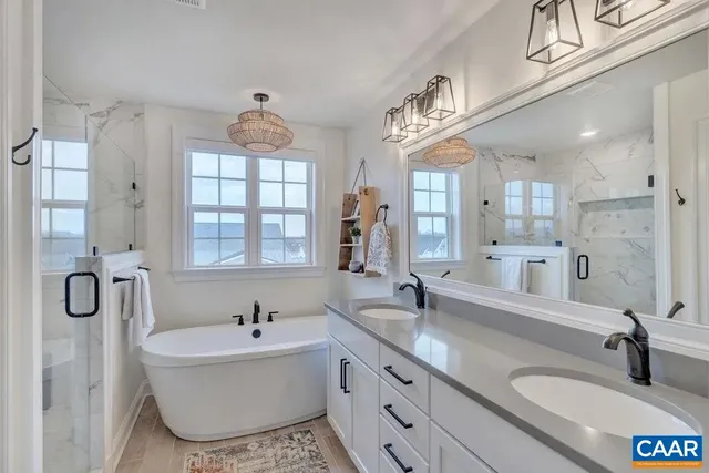 a bathroom with a granite countertop sink vanity mirror and a shower
