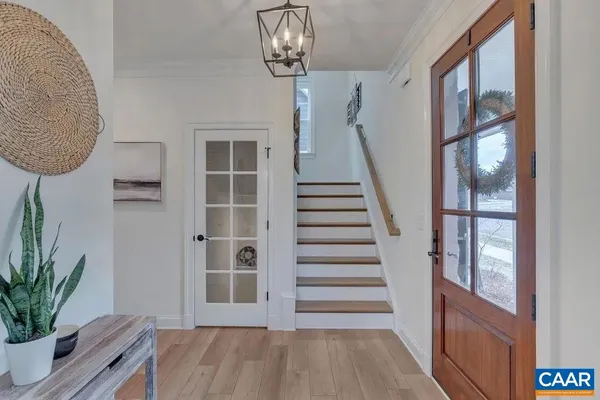 a view of a room with wooden floor and windows