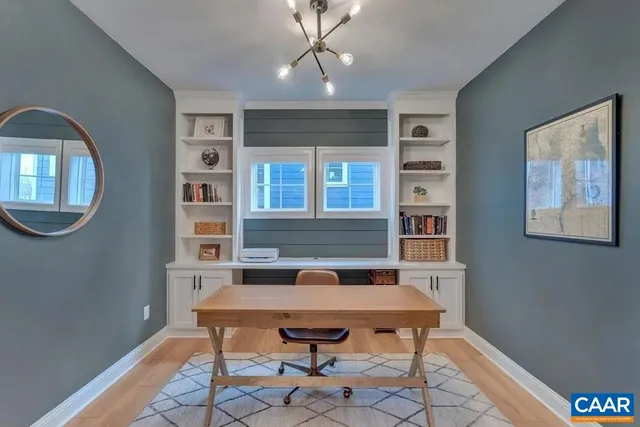 a view of a dining room with furniture wooden floor and chandelier