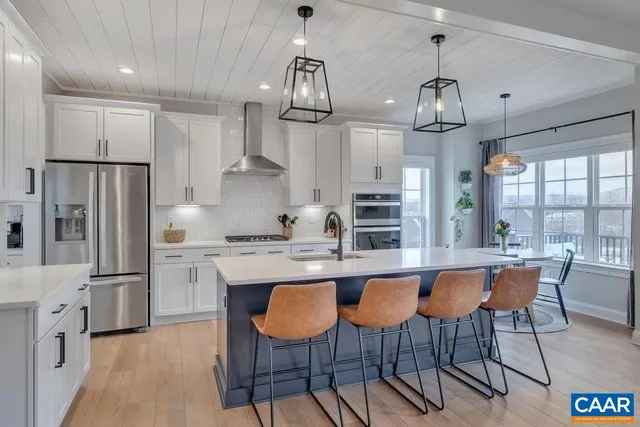 an open kitchen with sink and breakfast area