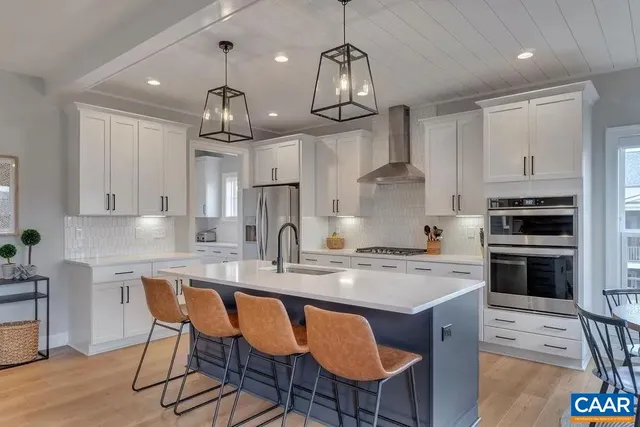 a view of a dining room with furniture wooden floor and chandelier