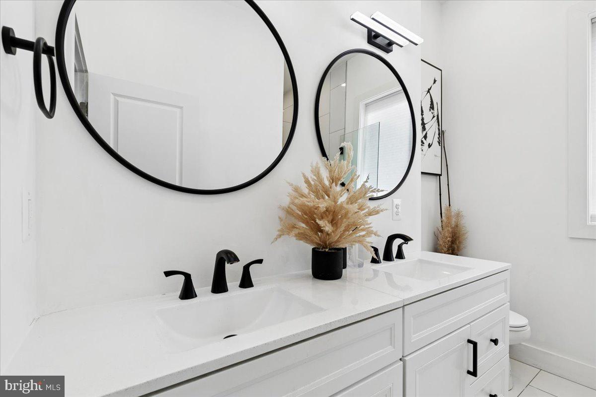 3249 Arundel On The Bay Road Annapolis, MD 21403 - Photo 35 of 88 a bathroom with a sink and a mirror