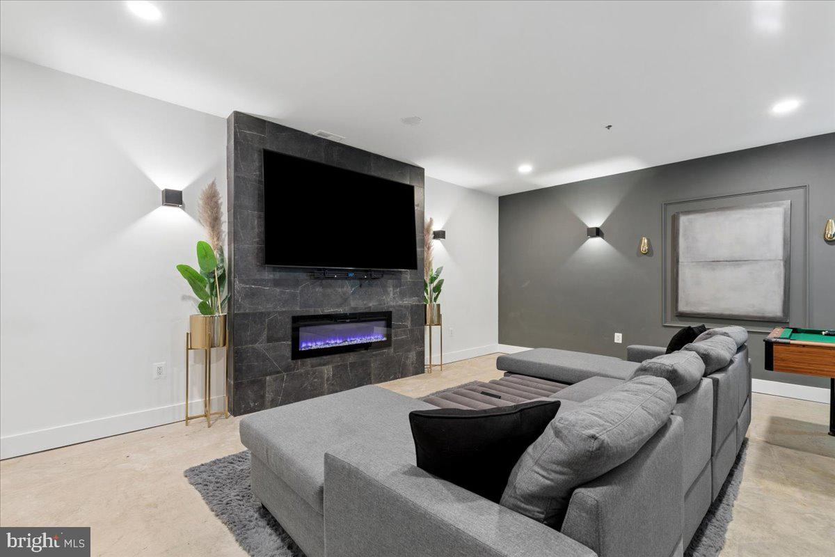 3249 Arundel On The Bay Road Annapolis, MD 21403 - Photo 36 of 88 a living room with furniture a fireplace and a flat screen tv