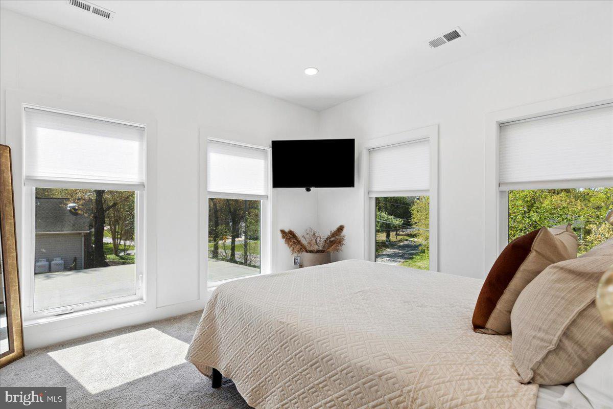 3249 Arundel On The Bay Road Annapolis, MD 21403 - Photo 50 of 88 a bedroom with a bed and a flat screen tv