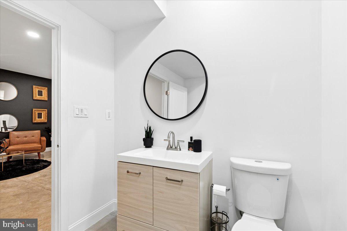 3249 Arundel On The Bay Road Annapolis, MD 21403 - Photo 59 of 88 a bathroom with a sink mirror and toilet