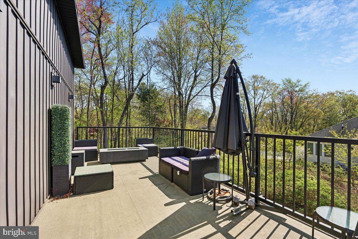 3249 Arundel On The Bay Road Annapolis, MD 21403 - Photo 67 of 88 a view of a balcony with wooden floor and outdoor seating